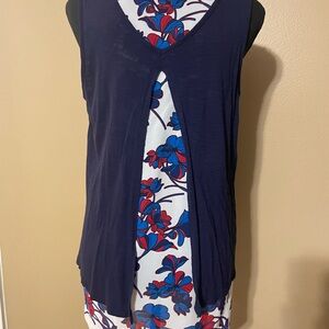 Sleeveless top. Floral print underneath the navy blue